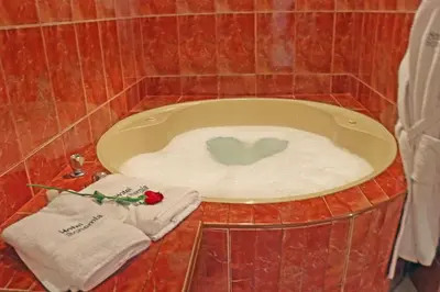 a bath tub with two towels and a heart in it at Hotel Bohemia in Lima