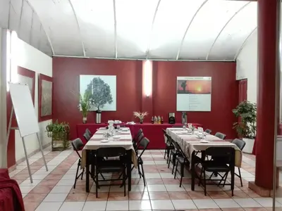 a dining room with tables and chairs and red walls at Los Q'eros in Lima