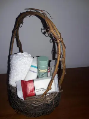 a basket filled with towels and toiletries on a table at Suzet House in Oxapampa