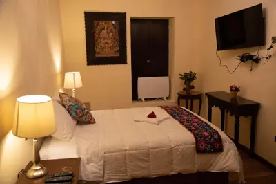 a bedroom with a bed with a flower on it at Cusco Hotel Boutique in Cusco