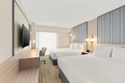 a hotel room with two beds and a tv at Holiday Inn Express - Lima San Isidro by IHG in Lima