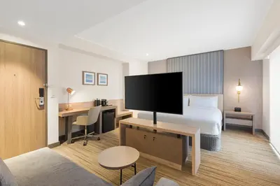 a hotel room with a bed and a flat screen tv at Holiday Inn Express - Lima San Isidro by IHG in Lima