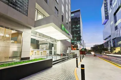 a building with a sidewalk in the middle of a city at Holiday Inn Express - Lima San Isidro by IHG in Lima