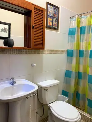 a bathroom with a toilet and a sink at Bungalows Perayoc in Urubamba