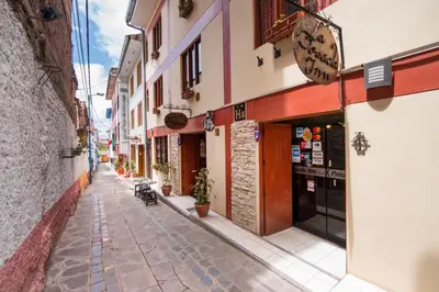 an empty street in an alley with buildings at Ayenda Posada Inn in Cusco