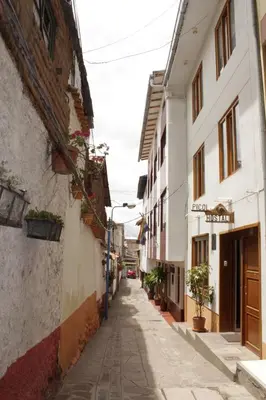 an alley in an old town with buildings at Picol Hostal in Cusco