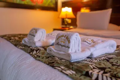 two towels on a bed in a hotel room at Gringo Bill's Boutique Hotel in Machu Picchu