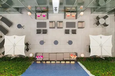 a rendering of a patio with umbrellas on a wall at Aloft Lima Miraflores in Lima