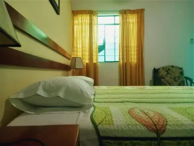 a bedroom with a bed and a window at Anccalla Inn Guesthouse in Nazca
