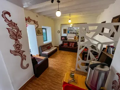 a living room with a couch and a living room with a ladder at Cusco Plaza Nazarenas in Cusco