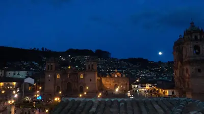 a view of a city at night at Hotel Plaza de Armas Cusco in Cusco