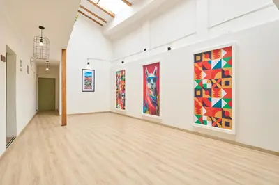 an art gallery with paintings on the walls at Centro by Casa Andina Cusco Saphi in Cusco