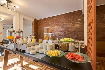 a buffet of food on a table with bowls of fruit at Centro by Casa Andina Cusco Saphi in Cusco