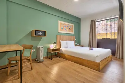 a hotel room with a bed and a table and a desk at Centro by Casa Andina Cusco Saphi in Cusco