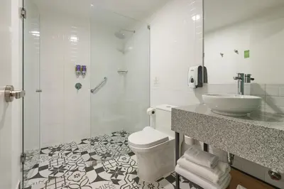 a bathroom with a toilet and a sink and a shower at Centro by Casa Andina Cusco Saphi in Cusco