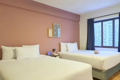 two beds in a room with a window at Centro by Casa Andina Cusco Saphi in Cusco