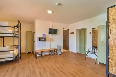a room with a bunk bed and a table at Centro by Casa Andina Cusco Saphi in Cusco