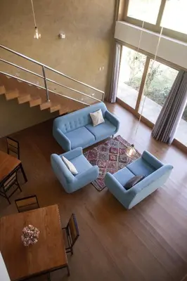 a living room with two blue couches and a table at Casafranca in Ollantaytambo