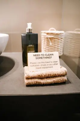 a bottle of soap sitting on a counter with a sign at Muru Homely Hotel Cusco in Cusco