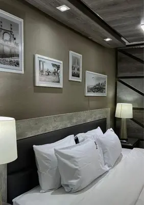 a bedroom with a bed with white sheets and pillows at Hotel El Marqués in Lima