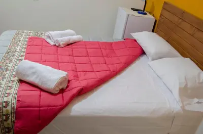 a bed with two towels on top of it at Jazmines Lodging in Ica