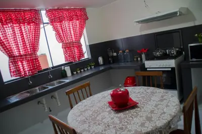 a kitchen with a table with a red bowl on it at Jazmines Lodging in Ica