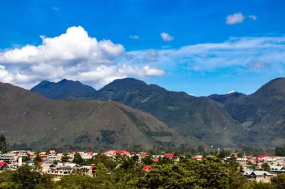 a view of a town in the mountains at HASSINGER RANCH Cabañas in Oxapampa
