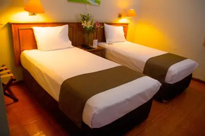 a hotel room with two beds in a room at DM Hoteles Mossone - Ica in Ica
