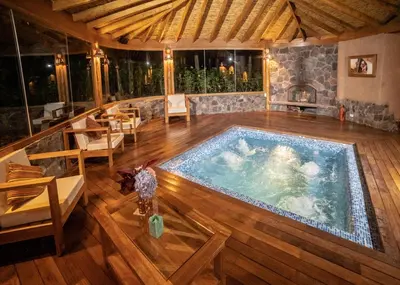 an indoor swimming pool in a room with wooden floors at Sacred Dreams Lodge in Urubamba