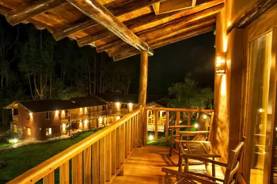 a deck with chairs and lights on a cabin at Sacred Dreams Lodge in Urubamba