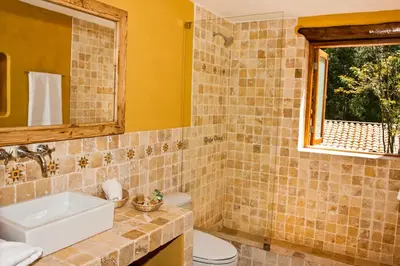 a bathroom with a sink and a toilet and a window at Sacred Dreams Lodge in Urubamba