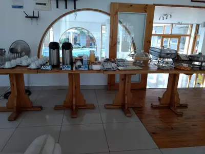a large wooden table with food on top of it at Hotel Boutique La Angostura in Ica