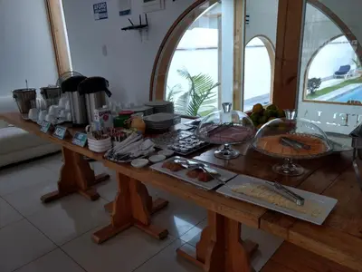 a wooden table with food on it in a kitchen at Hotel Boutique La Angostura in Ica