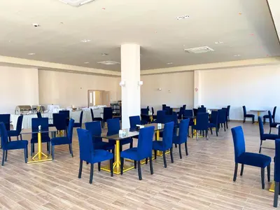 a dining room with blue chairs and tables at DM Hoteles Nasca in Nazca