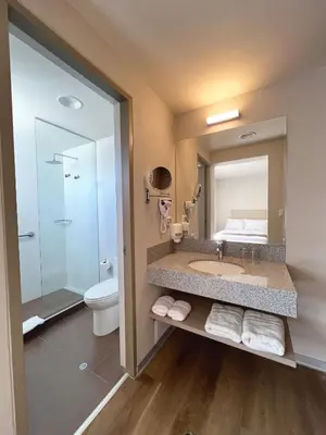 a bathroom with a sink and a toilet and a mirror at DM Hoteles Nasca in Nazca