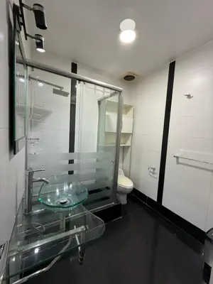 a bathroom with a glass sink and a toilet at Private room in Miraflores; Exclusive entrance! in Lima