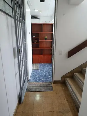 a hallway with stairs leading up to a door at Room 5 Star Miraflores in Lima