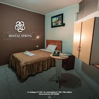 a small room with a bed and a table at Hostal Spring II in Huánuco