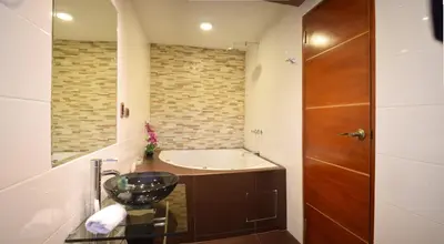a bathroom with a tub and a sink at Ankawa Hotel Boutique in Cusco