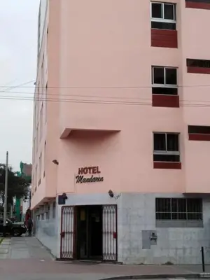 a hotel manufacturer sign on the side of a building at Hotel Mandarin in Lima