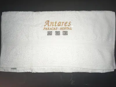 a white towel with the words armies paraisolis hospital at Antares Paracas in Paracas
