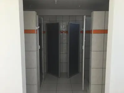 an empty bathroom with two doors in a room at Antares Paracas in Paracas