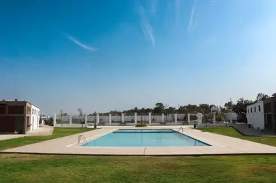 a large swimming pool in the middle of a park at Bodega el Huarango in Ica