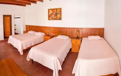 a room with two beds and two lamps on tables at Bodega el Huarango in Ica