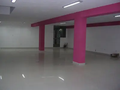 a large room with red columns in a building at Suites El Parque in Lima