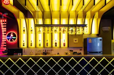 a bar with yellow pipes on the wall at Hotel Costa Riviera in Mala