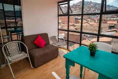 a living room with a couch and a table at The Chusay Rooftop in Cusco