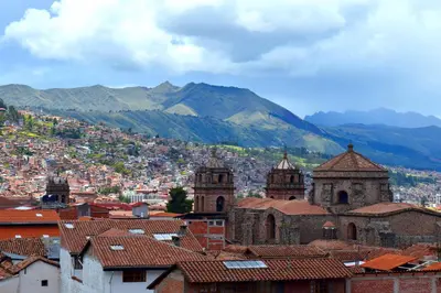 a view of a city with mountains in the background at The Chusay Rooftop in Cusco