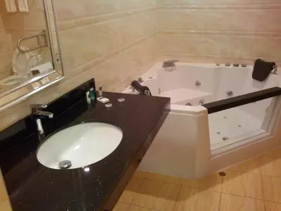 a bathroom with a sink and a bath tub at Hotel Candamo in Lima