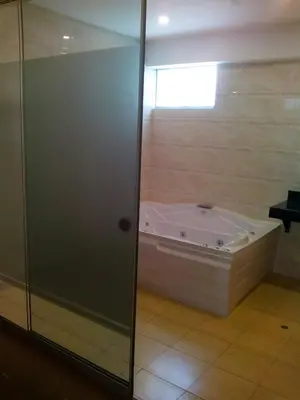 a bath tub in a bathroom with a shower at Hotel Candamo in Lima